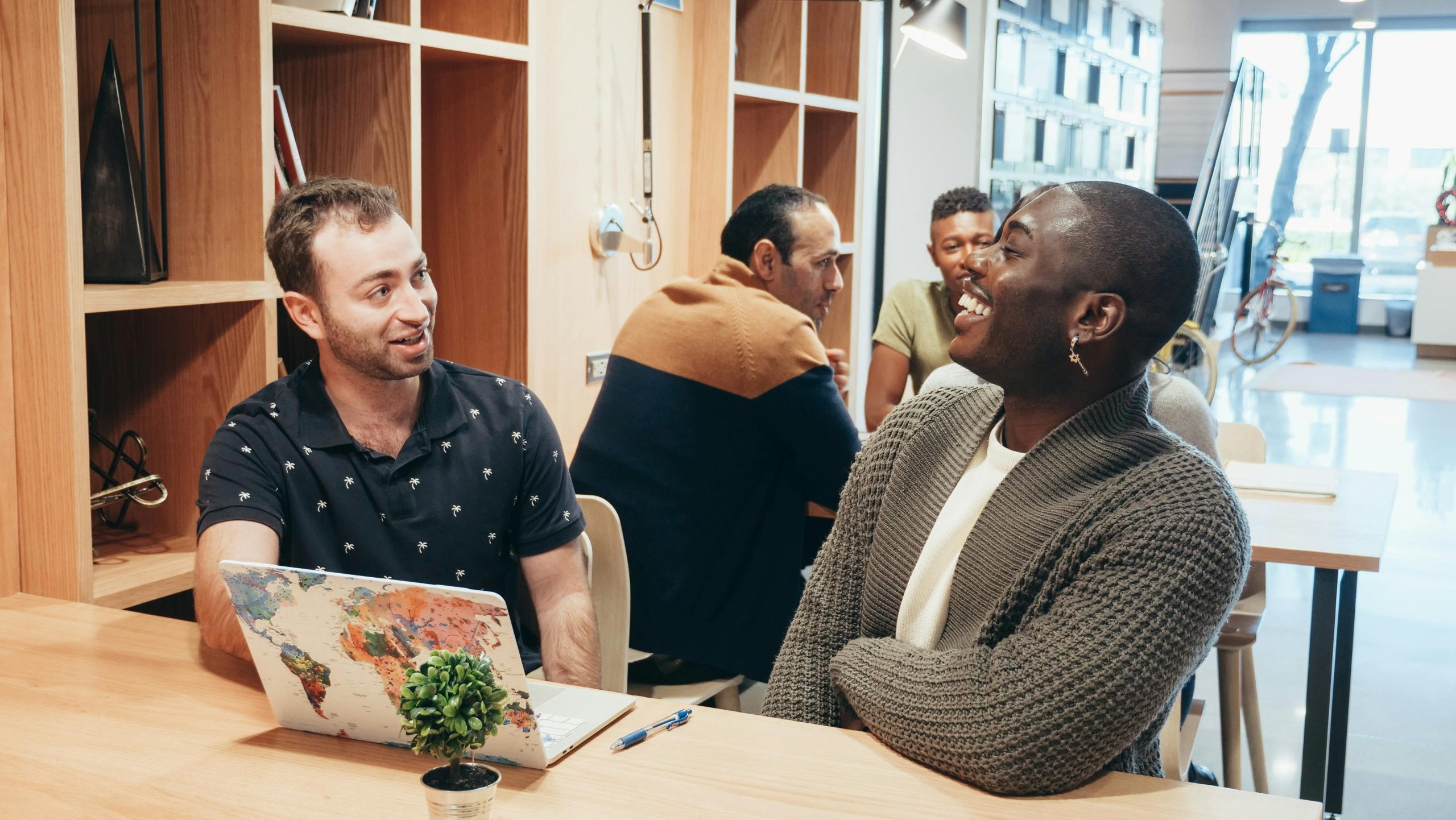 Diverse workplace team discussing open-ended questions across cultures